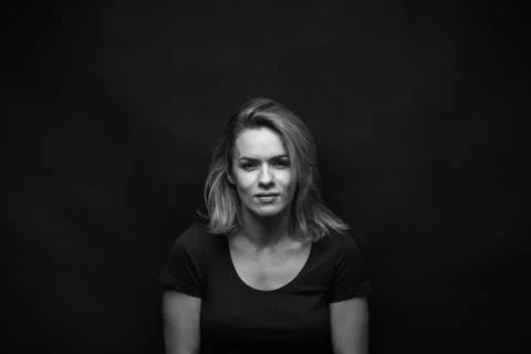 Dramatic black and white portrait of a beautiful woman on a dark background Stock Photos
