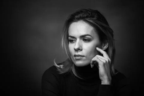 Dramatic black and white portrait of a beautiful woman on a dark background Stock Photos