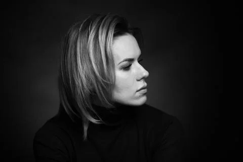 Dramatic black and white portrait of a beautiful woman on a dark background Stock Photos