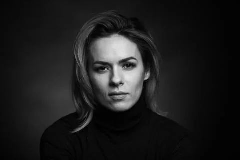 Dramatic black and white portrait of a beautiful woman on a dark background Stock Photos