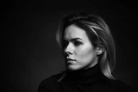 Dramatic black and white portrait of a beautiful woman on a dark background Stock Photos