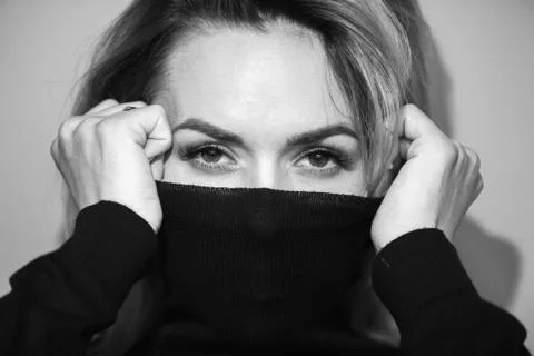 Dramatic black and white portrait of a beautiful woman on a dark background Stock Photos