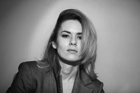 Dramatic black and white portrait of a beautiful woman on a dark background Stock Photos