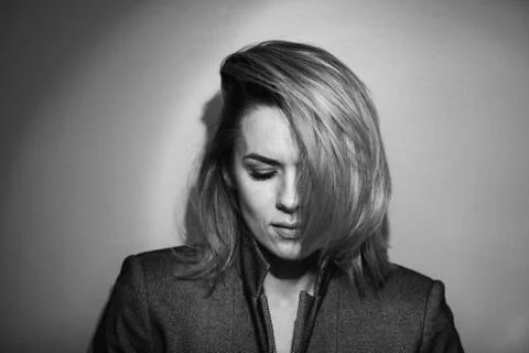 Dramatic black and white portrait of a beautiful woman on a dark background Stock Photos