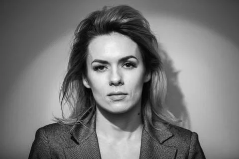 Dramatic black and white portrait of a beautiful woman on a dark background Stock Photos