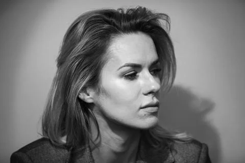 Dramatic black and white portrait of a beautiful woman on a dark background Stock Photos