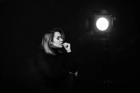 Dramatic black and white portrait of a beautiful woman on a dark background Stock Photos