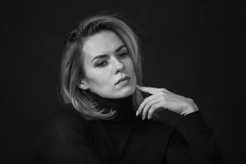 Dramatic black and white portrait of a beautiful woman on a dark background Stock Photos