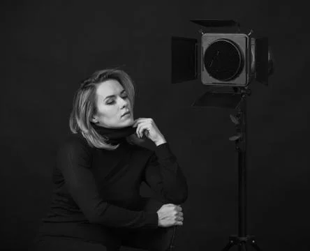 Dramatic black and white portrait of a beautiful woman on a dark background Stock Photos
