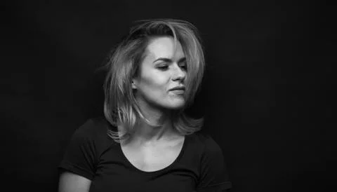 Dramatic black and white portrait of a beautiful woman on a dark background Stock Photos