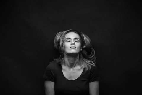 Dramatic black and white portrait of a beautiful woman on a dark background Stock Photos