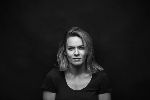 Dramatic black and white portrait of a beautiful woman on a dark background Stock Photos