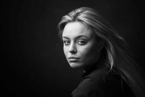 Dramatic black and white portrait of a beautiful woman on a dark background Stock Photos
