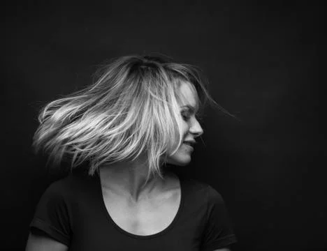 Dramatic black and white portrait of a beautiful woman on a dark background Stock Photos