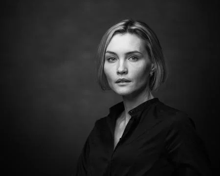 Dramatic black and white portrait of a beautiful woman on a dark background Stock Photos