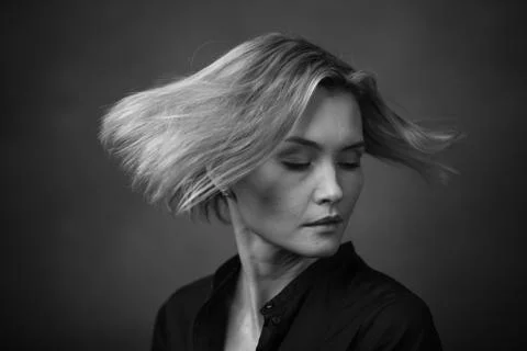Dramatic black and white portrait of a beautiful woman on a dark background Stock Photos