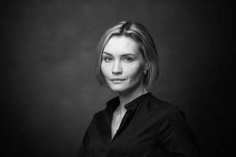 Dramatic black and white portrait of a beautiful woman on a dark background Stock Photos