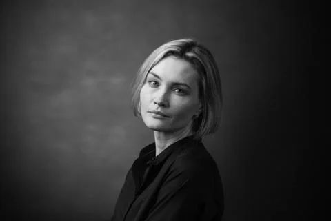 Dramatic black and white portrait of a beautiful woman on a dark background Stock Photos