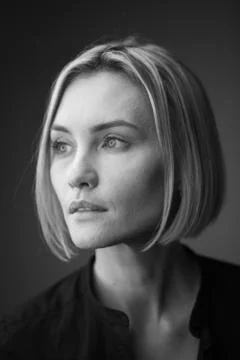 Dramatic black and white portrait of a beautiful woman on a dark background Stock Photos