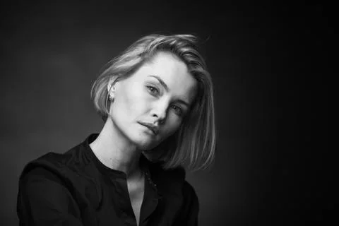 Dramatic black and white portrait of a beautiful woman on a dark background Stock Photos