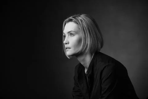 Dramatic black and white portrait of a beautiful woman on a dark background Stock Photos