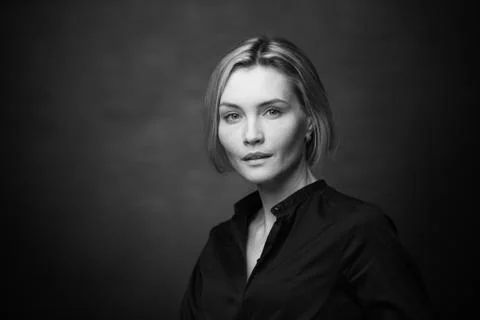 Dramatic black and white portrait of a beautiful woman on a dark background Stock Photos