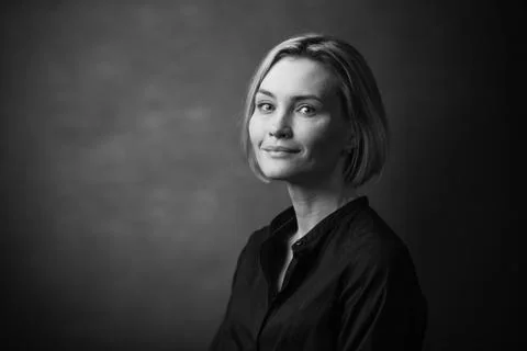 Dramatic black and white portrait of a beautiful woman on a dark background Stock Photos