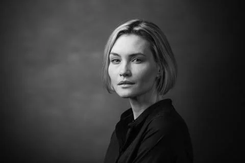 Dramatic black and white portrait of a beautiful woman on a dark background Stock Photos