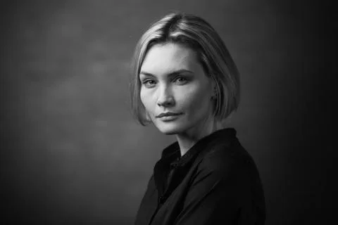 Dramatic black and white portrait of a beautiful woman on a dark background Stock Photos