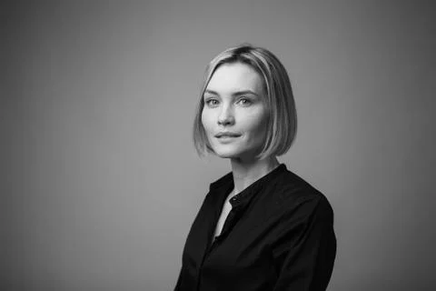 Dramatic black and white portrait of a beautiful woman on a dark background Stock Photos