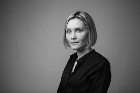 Dramatic black and white portrait of a beautiful woman on a dark background Stock Photos