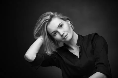 Dramatic black and white portrait of a beautiful woman on a dark background Stock Photos
