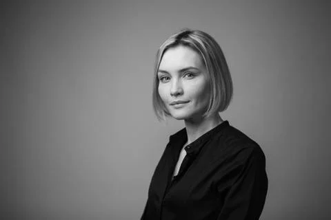Dramatic black and white portrait of a beautiful woman on a dark background Stock Photos