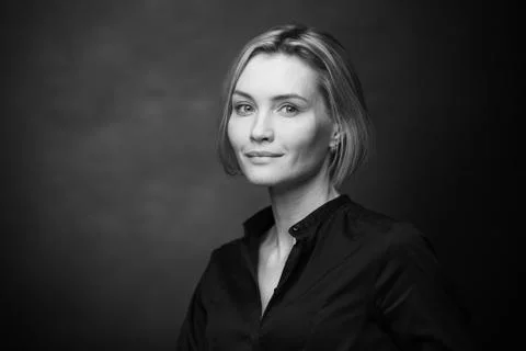 Dramatic black and white portrait of a beautiful woman on a dark background Stock Photos