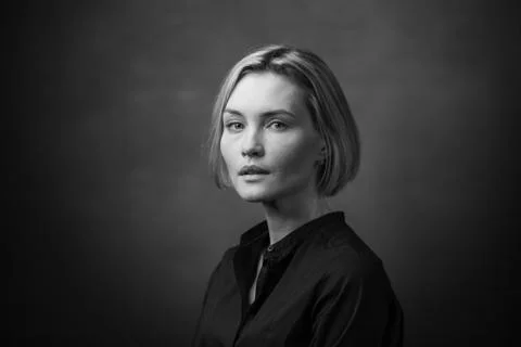 Dramatic black and white portrait of a beautiful woman on a dark background Stock Photos