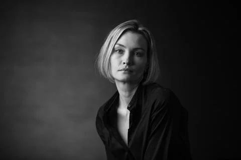 Dramatic black and white portrait of a beautiful woman on a dark background Stock Photos