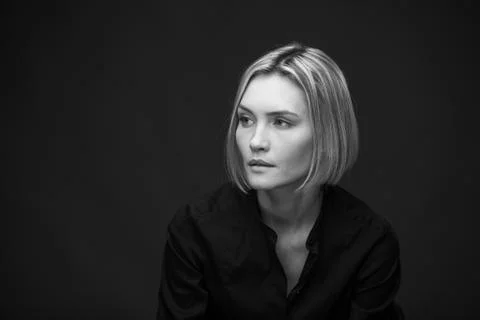 Dramatic black and white portrait of a beautiful woman on a dark background Stock Photos