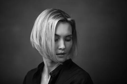 Dramatic black and white portrait of a beautiful woman on a dark background Stock Photos