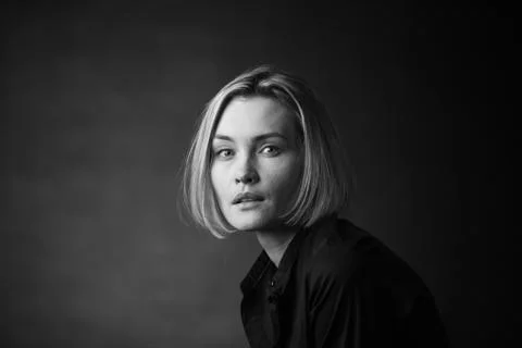 Dramatic black and white portrait of a beautiful woman on a dark background Stock Photos