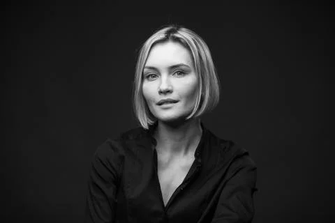 Dramatic black and white portrait of a beautiful woman on a dark background Stock Photos