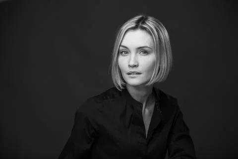 Dramatic black and white portrait of a beautiful woman on a dark background Stock Photos