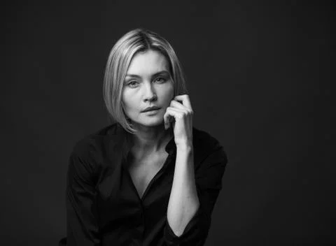 Dramatic black and white portrait of a beautiful woman on a dark background Stock Photos