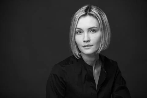 Dramatic black and white portrait of a beautiful woman on a dark background Stock Photos