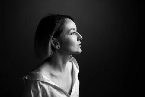 Dramatic black and white portrait of a beautiful woman on a dark background Stock Photos