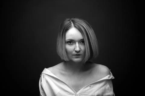 Dramatic black and white portrait of a beautiful woman on a dark background Stock Photos