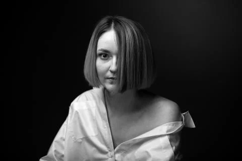 Dramatic black and white portrait of a beautiful woman on a dark background Stock Photos