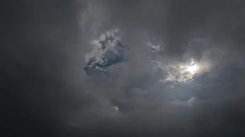 Dramatic black cloud timelapse rolling over the sun Stock Footage 320978922