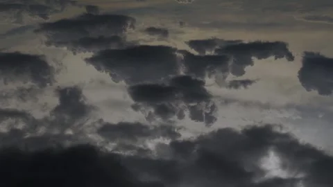 Dramatic black dark rain clouds are approaching flying in the sky in sunlight, s Vídeos de archivo 332216808