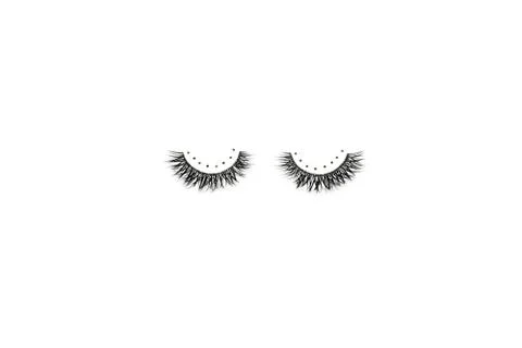 Dramatic black long false eyelashes decorated with bright sparkling golden gl Stock Photos