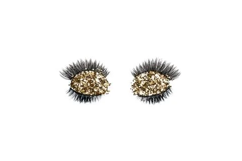 Dramatic black long false eyelashes decorated with bright sparkling golden gl Stock Photos